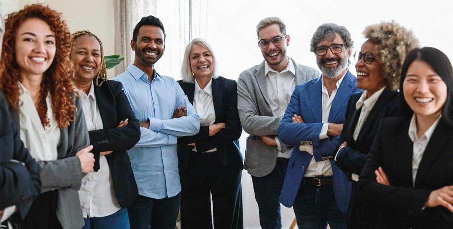 Diverse team of UAE business professionals standing together in an office