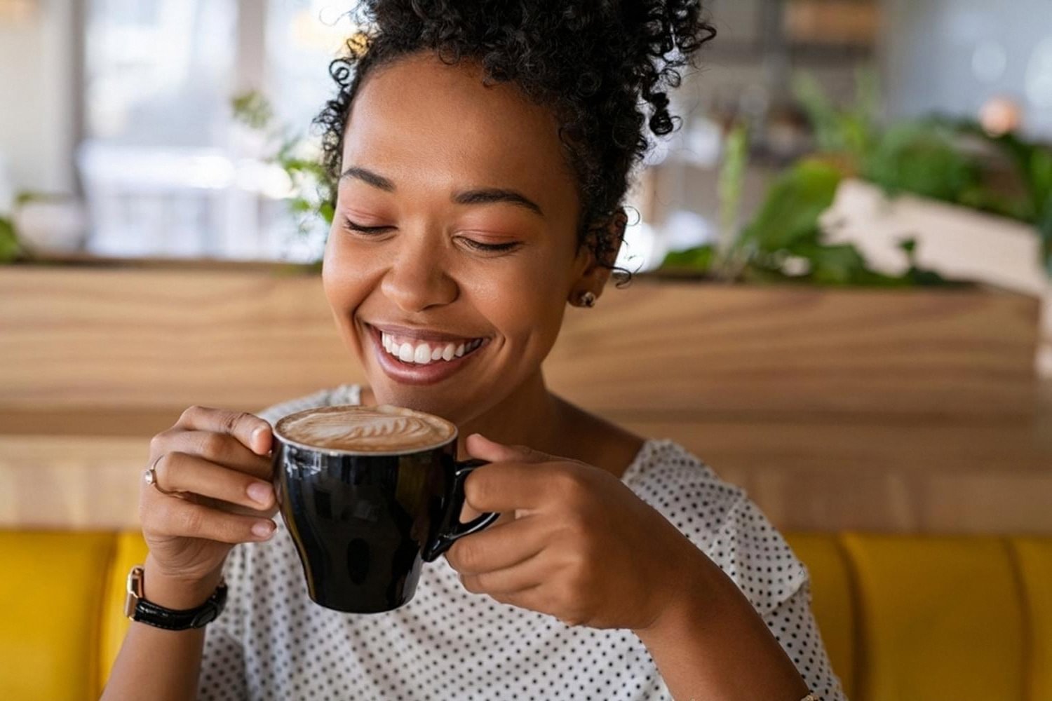 Young woman enjoying a cup of flavored Arabica coffee at a Dubai cafe